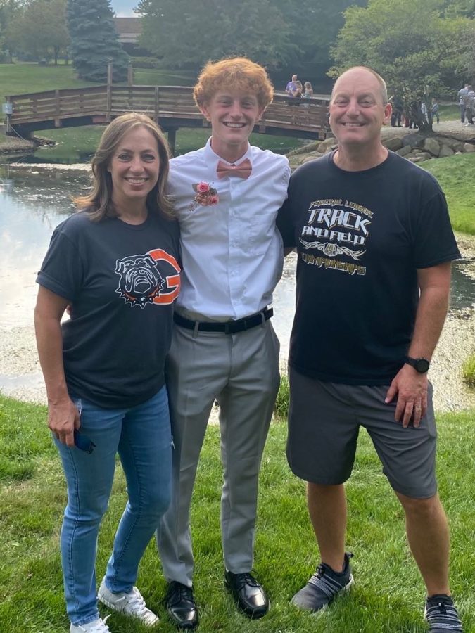 Carter Hane and both of his parents/teachers before Homecoming this year.