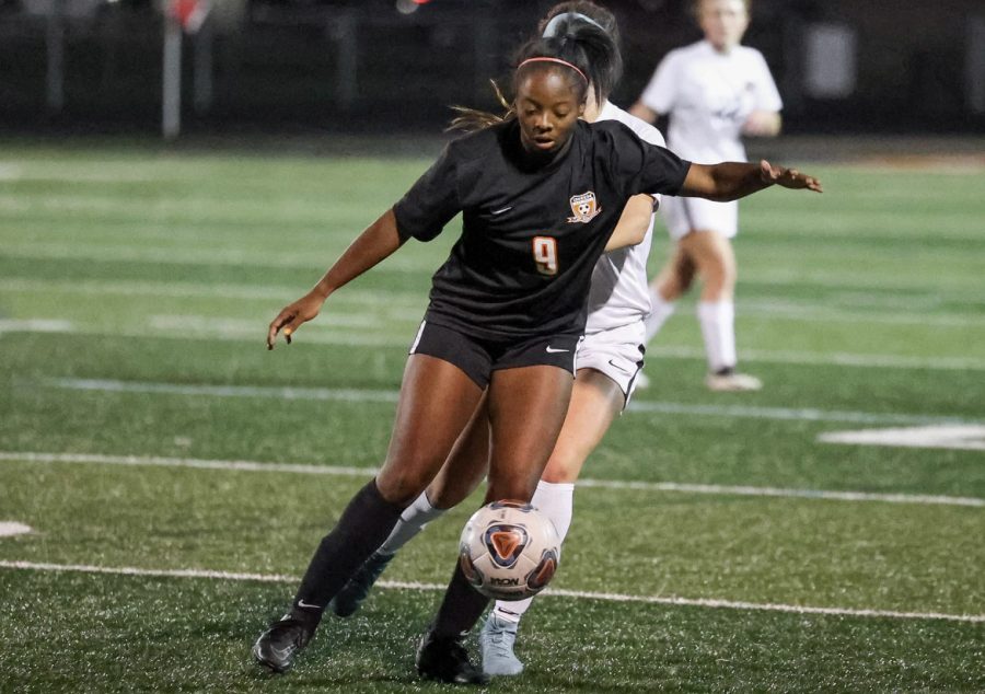 Junior Alaina Bradford defending the ball from Howland player on October 24, 2022.