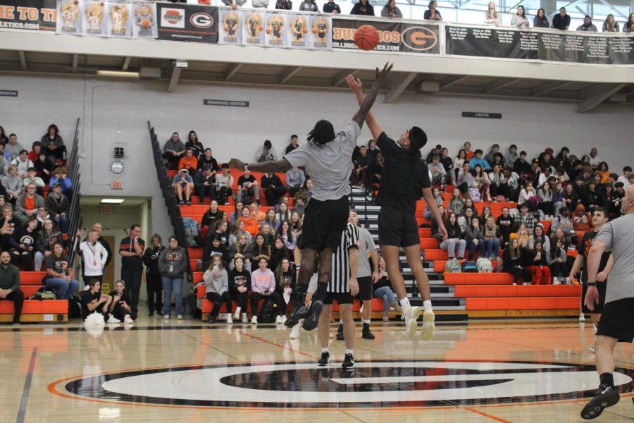 Isaiah Weirich '23 and Mr. Tiron Jester jump for the ball to begin the game.